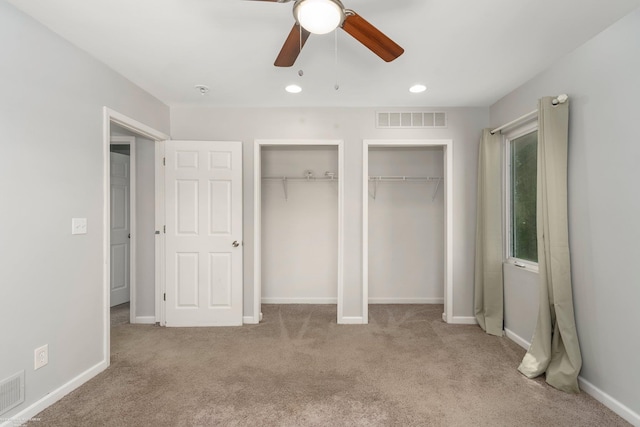 unfurnished bedroom with two closets, carpet flooring, recessed lighting, ceiling fan, and baseboards