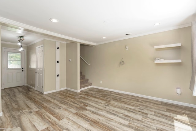 unfurnished living room featuring crown molding, wood finished floors, stairs, baseboards, and recessed lighting