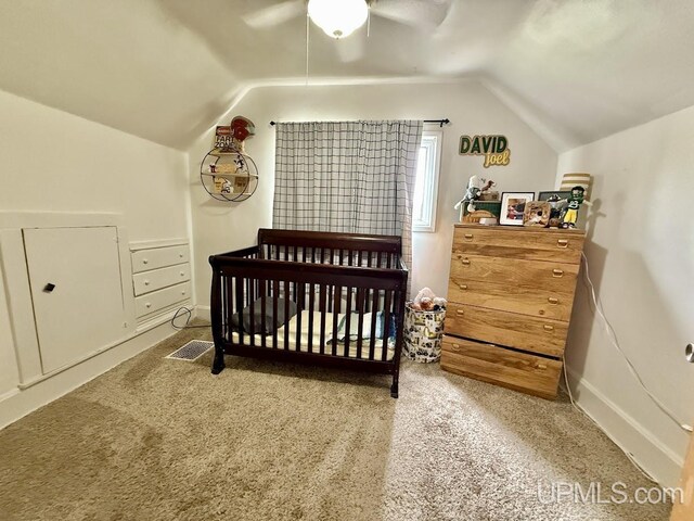 624 S 16th St, Escanaba, MI 49829 - carpeted bedroom with vaulted ceiling, a ceiling fan, a crib, and baseboards