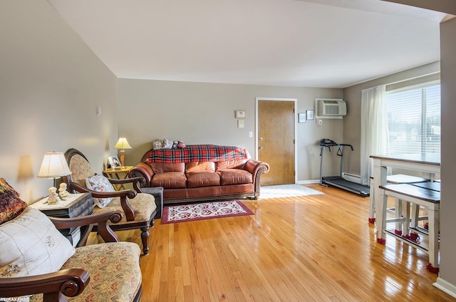 34485 Garfield Rd Apt # 1, Fraser, MI 48026 - living room featuring a wall mounted air conditioner, light wood finished floors, baseboard heating, and baseboards