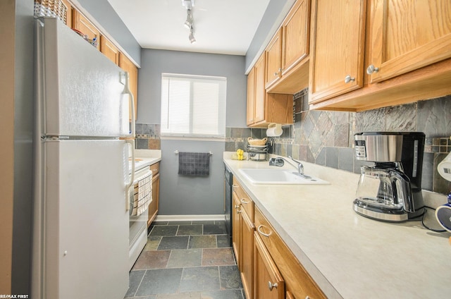 34485 Garfield Rd Apt # 1, Fraser, MI 48026 - kitchen featuring freestanding refrigerator, light countertops, backsplash, a sink, and baseboards