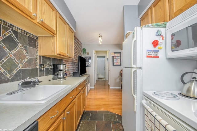 34485 Garfield Rd Apt # 1, Fraser, MI 48026 - kitchen featuring white appliances, a sink, light countertops, tasteful backsplash, and dark stone finish flooring