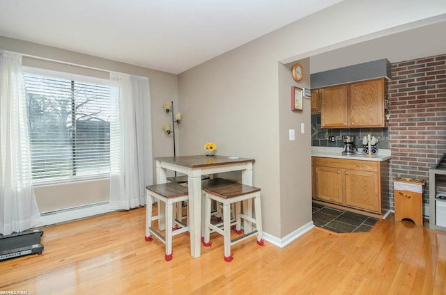 34485 Garfield Rd Apt # 1, Fraser, MI 48026 - dining area with light wood-style flooring, baseboards, and baseboard heating