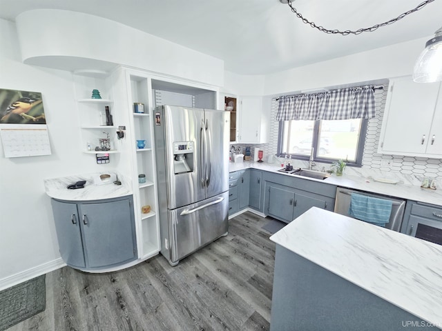 1400 W B St, Iron Mountain, MI 49801 - kitchen featuring appliances with stainless steel finishes, a sink, wood finished floors, and open shelves