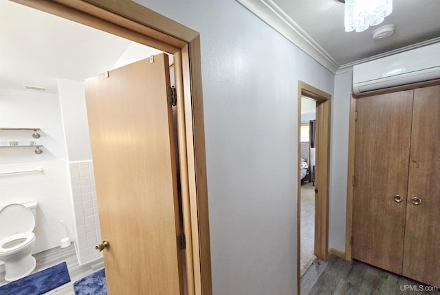 1400 W B St, Iron Mountain, MI 49801 - hallway featuring a wall unit AC, wood finished floors, crown molding, and tile walls