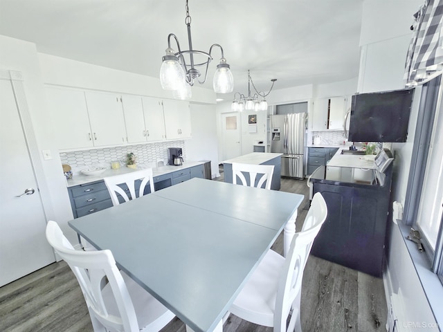 1400 W B St, Iron Mountain, MI 49801 - dining area featuring dark wood finished floors and a chandelier