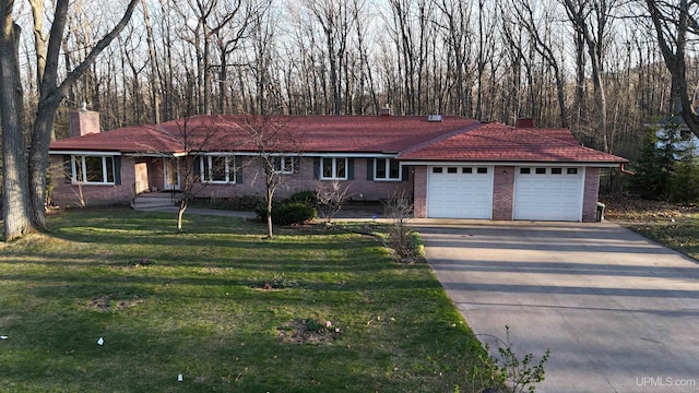 1002 Allouez Rd, Marquette, MI 49855 - ranch-style home featuring a chimney, an attached garage, asphalt driveway, a front lawn, and brick siding