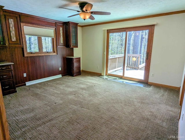 1002 Allouez Rd, Marquette, MI 49855 - unfurnished living room with baseboard heating, healthy amount of natural light, a ceiling fan, baseboards, and ornamental molding