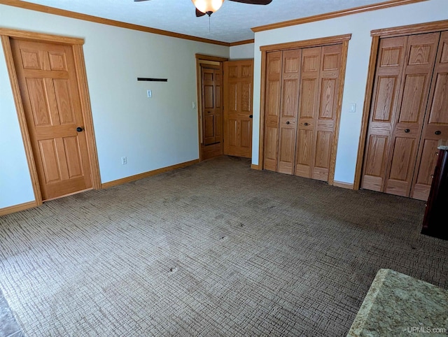 1002 Allouez Rd, Marquette, MI 49855 - unfurnished bedroom with carpet flooring, two closets, baseboards, ornamental molding, and a ceiling fan