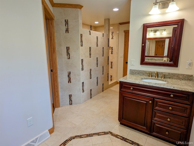 1002 Allouez Rd, Marquette, MI 49855 - bathroom featuring vanity, tile patterned floors, a tile shower, and recessed lighting