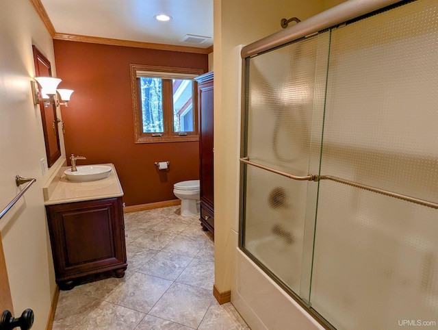 1002 Allouez Rd, Marquette, MI 49855 - full bathroom featuring toilet, vanity, crown molding, baseboards, and tile patterned flooring