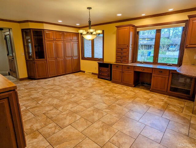 1002 Allouez Rd, Marquette, MI 49855 - kitchen featuring brown cabinets, baseboards, a chandelier, pendant lighting, and crown molding