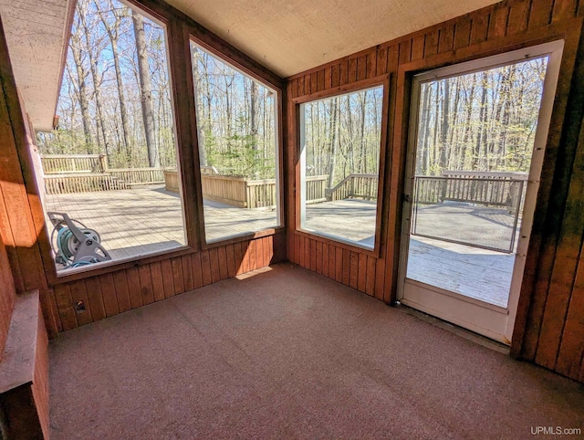 1002 Allouez Rd, Marquette, MI 49855 - unfurnished sunroom featuring carpet, wood walls, and vaulted ceiling