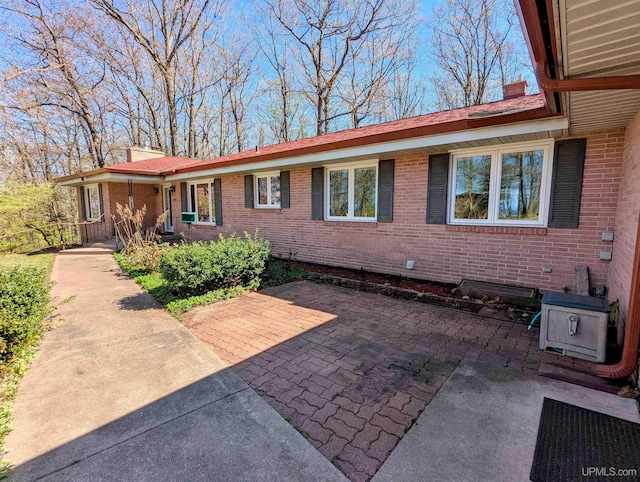 1002 Allouez Rd, Marquette, MI 49855 - view of front of property with a chimney, brick siding, and a patio