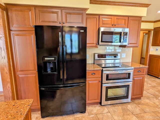 1002 Allouez Rd, Marquette, MI 49855 - kitchen featuring appliances with stainless steel finishes, ornamental molding, light stone counters, backsplash, and brown cabinets