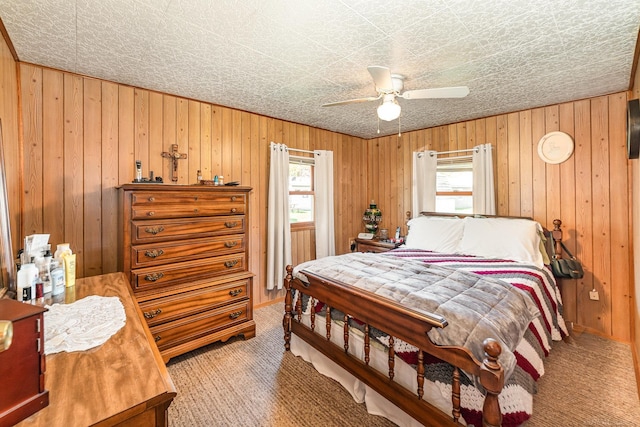 125 Wickham Ave, Houghton Lake, MI 48629 - bedroom with wood walls, carpet flooring, and a ceiling fan