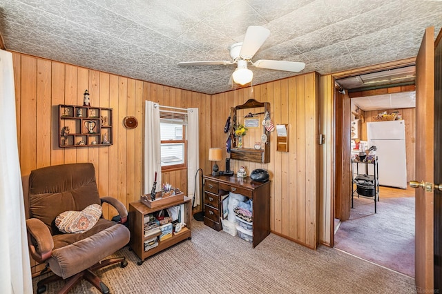 125 Wickham Ave, Houghton Lake, MI 48629 - sitting room featuring carpet flooring, wood walls, ceiling fan, attic access, and baseboards