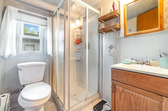 125 Wickham Ave, Houghton Lake, MI 48629 - full bathroom with tile walls, a shower stall, a baseboard heating unit, vanity, and toilet