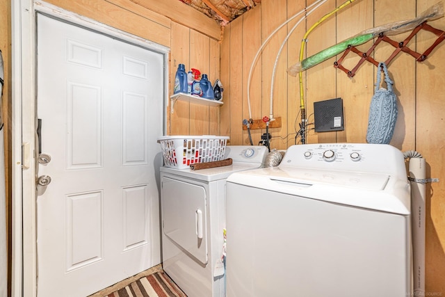 125 Wickham Ave, Houghton Lake, MI 48629 - washroom with washing machine and dryer and wood walls