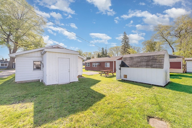 125 Wickham Ave, Houghton Lake, MI 48629 - view of grassy yard featuring a storage unit and an outdoor structure