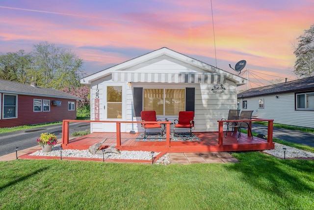 125 Wickham Ave, Houghton Lake, MI 48629 - rear view of house featuring a wooden deck and a yard