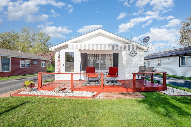 125 Wickham Ave, Houghton Lake, MI 48629 - rear view of property with a wooden deck and a lawn