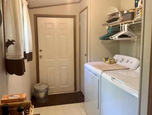 washroom with washer and dryer, tile patterned floors, and ornamental molding