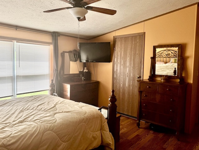 bedroom with a textured ceiling, wood finished floors, vaulted ceiling, a ceiling fan, and ornamental molding