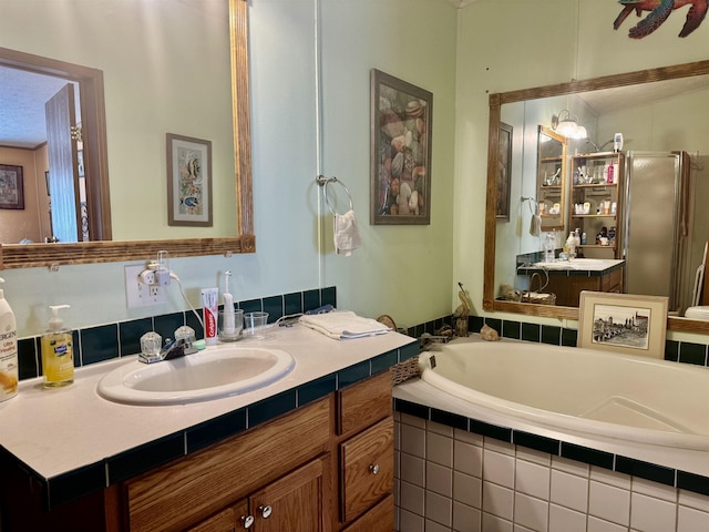 full bath featuring a stall shower, a garden tub, and vanity