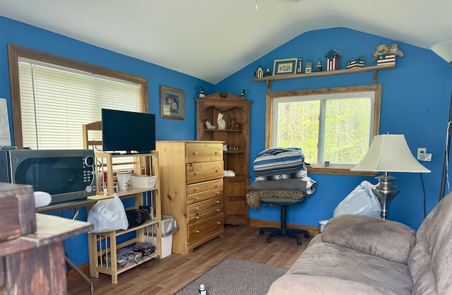 home office featuring lofted ceiling and wood finished floors