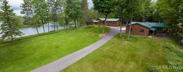 382 S Shore Dr, Crystal Falls, MI 49920 - view of green lawn with a water view, asphalt driveway, and view of wooded area