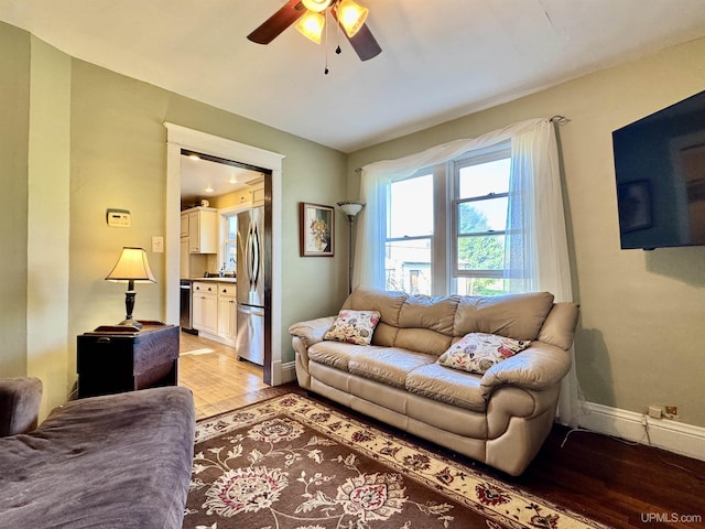 18020 Lake Rd, Pelkie, MI 49958 - living area with light wood-style floors, baseboards, and a ceiling fan