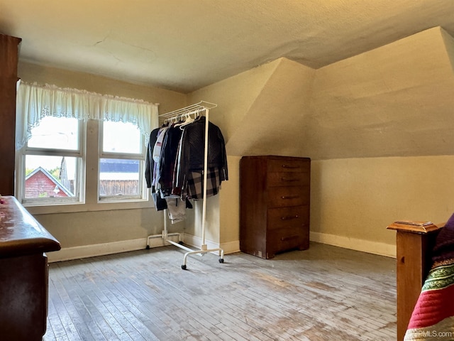 18020 Lake Rd, Pelkie, MI 49958 - walk in closet with hardwood / wood-style floors and lofted ceiling