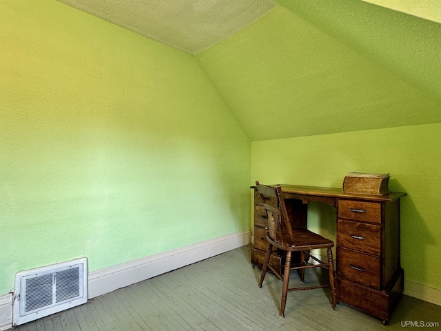 18020 Lake Rd, Pelkie, MI 49958 - home office featuring lofted ceiling, wood-type flooring, baseboards, and a textured ceiling