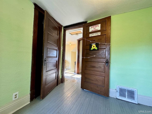 18020 Lake Rd, Pelkie, MI 49958 - hall featuring hardwood / wood-style flooring, baseboards, and a textured wall
