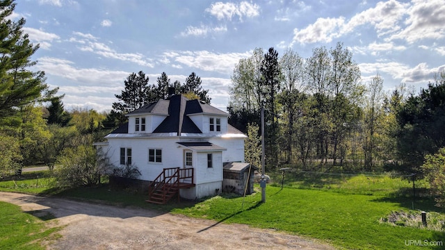 18020 Lake Rd, Pelkie, MI 49958 - view of front of house with a front lawn and a chimney