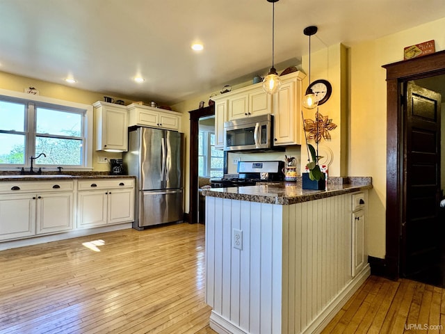 18020 Lake Rd, Pelkie, MI 49958 - kitchen featuring stainless steel appliances, a sink, light wood-style flooring, a peninsula, and recessed lighting