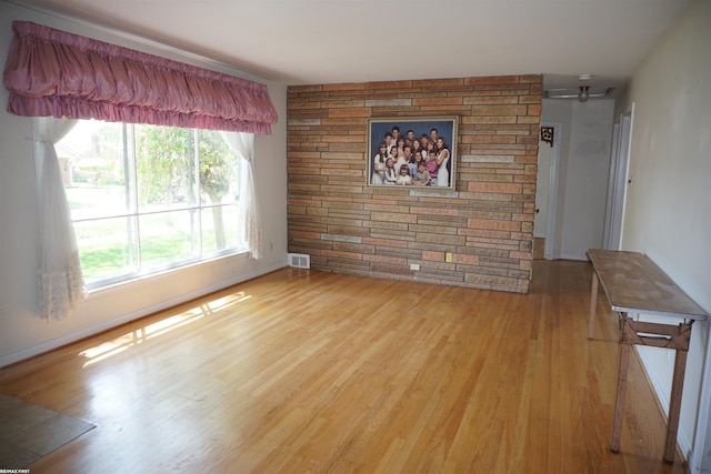 unfurnished room featuring wood finished floors and baseboards