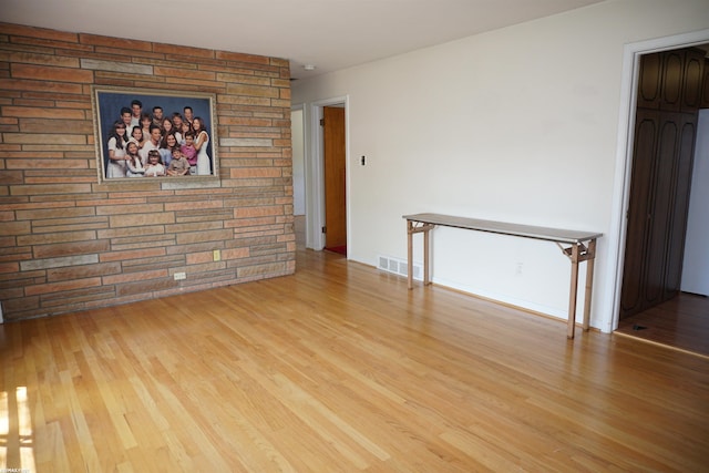 spare room featuring wood finished floors and baseboards