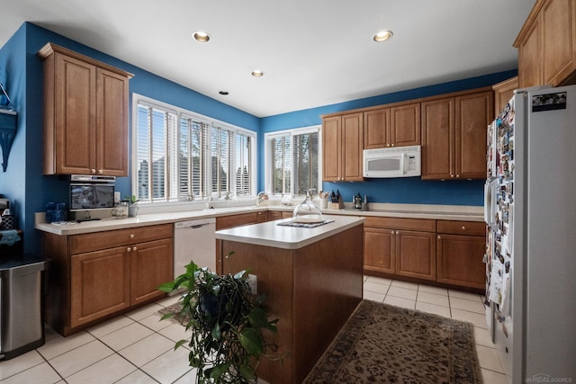 6517 Chelsea Brg, West Bloomfield, MI 48322 - kitchen featuring white appliances, light tile patterned floors, light countertops, brown cabinetry, and recessed lighting