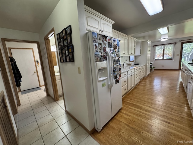 102 Forest Dr, Norway, MI 49870 - kitchen with white fridge with ice dispenser, light countertops, light wood-style floors, and baseboards