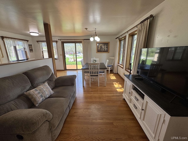 102 Forest Dr, Norway, MI 49870 - living room featuring wood finished floors, plenty of natural light, and a chandelier