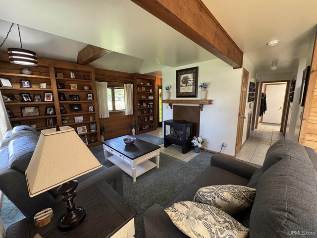 102 Forest Dr, Norway, MI 49870 - living area featuring beamed ceiling, tile patterned flooring, and a wood stove