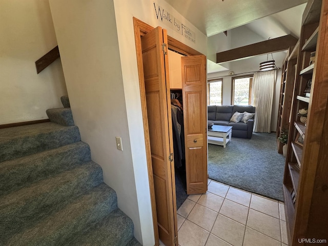 102 Forest Dr, Norway, MI 49870 - staircase with carpet floors, vaulted ceiling, and tile patterned floors