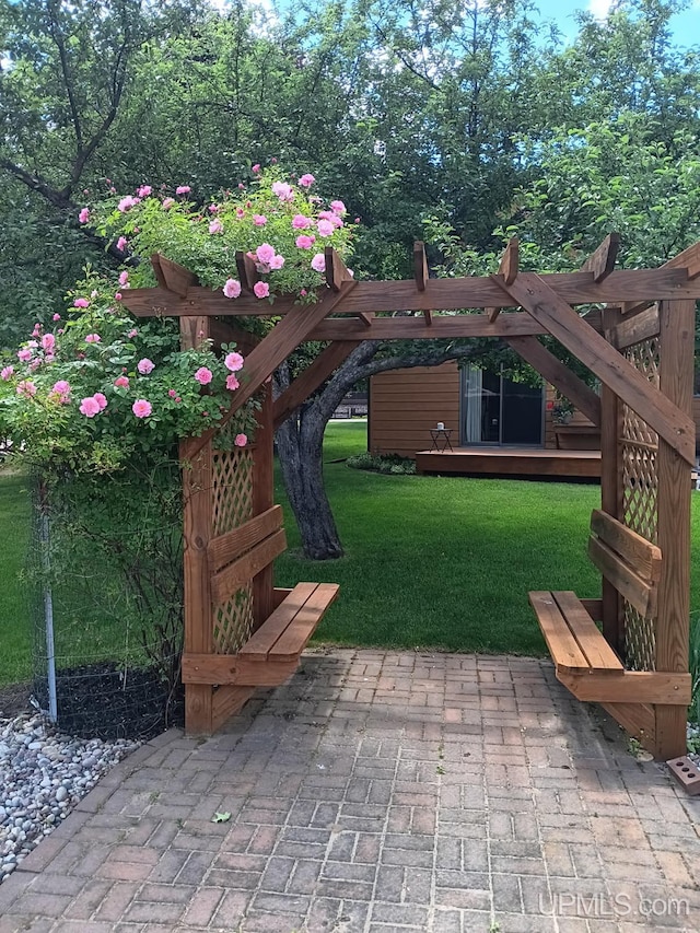 102 Forest Dr, Norway, MI 49870 - view of green lawn with a patio area and a wooden deck
