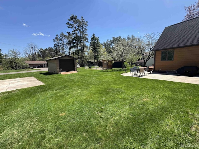 102 Forest Dr, Norway, MI 49870 - view of green lawn featuring a patio, an outdoor structure, a storage unit, and a detached garage