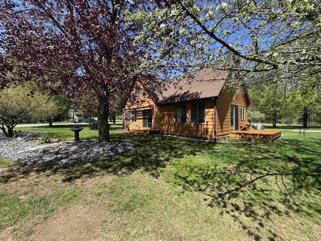 102 Forest Dr, Norway, MI 49870 - view of property exterior featuring a lawn, a deck, and a shingled roof