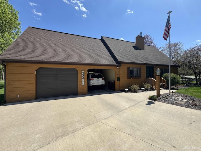 102 Forest Dr, Norway, MI 49870 - chalet / cabin with concrete driveway, a chimney, an attached garage, and roof with shingles