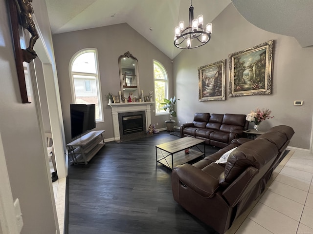 53641 Buckingham Ln, Shelby Twp, MI 48316 - living room featuring vaulted ceiling, a chandelier, a fireplace, baseboards, and wood finished floors