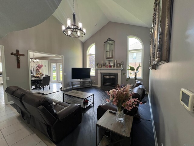 53641 Buckingham Ln, Shelby Twp, MI 48316 - living room with a chandelier, healthy amount of natural light, lofted ceiling, and a fireplace with flush hearth